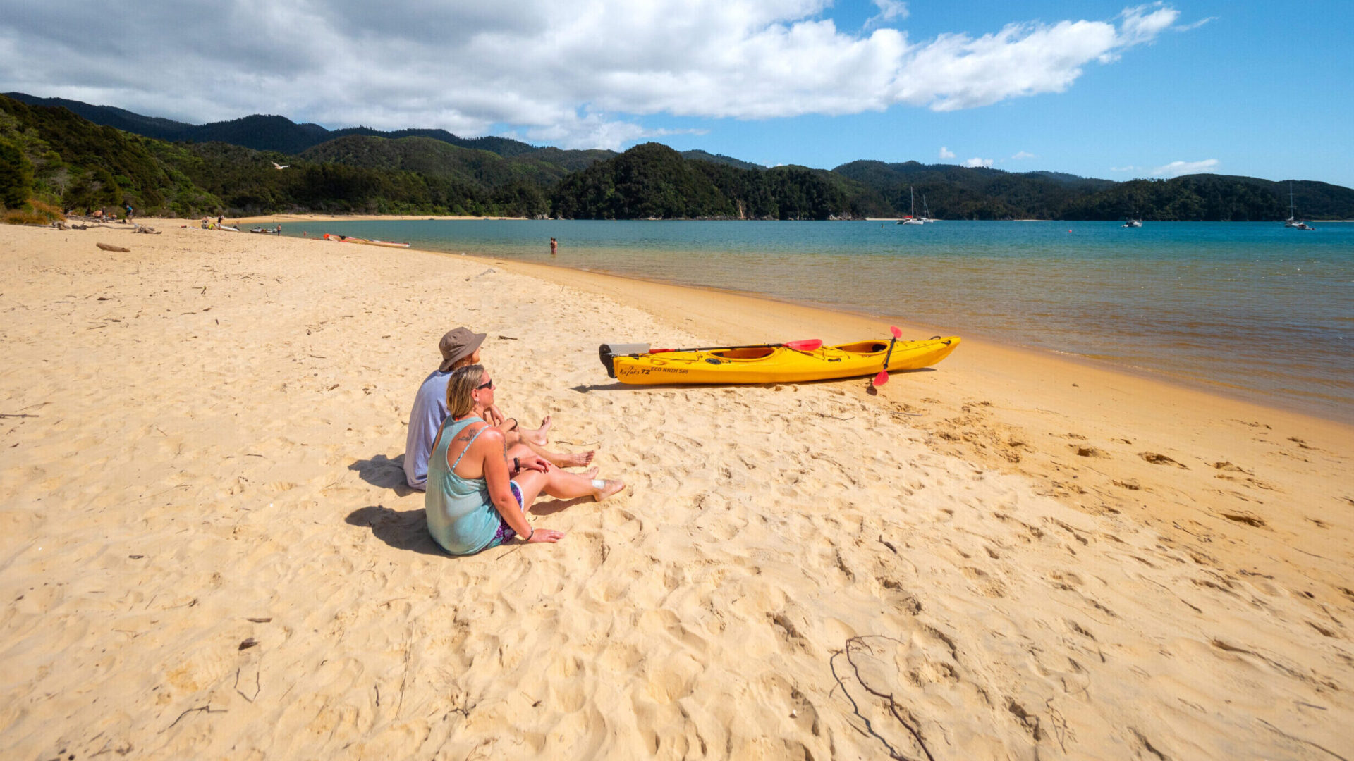 Couple And Kayaks On Kaiteriteri Beach Couple And Kayaks On Kaiteriteri Beach