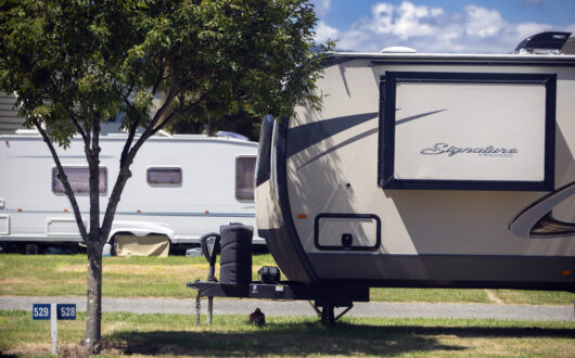Campervan parked at Tāhuna Beach Holiday Park