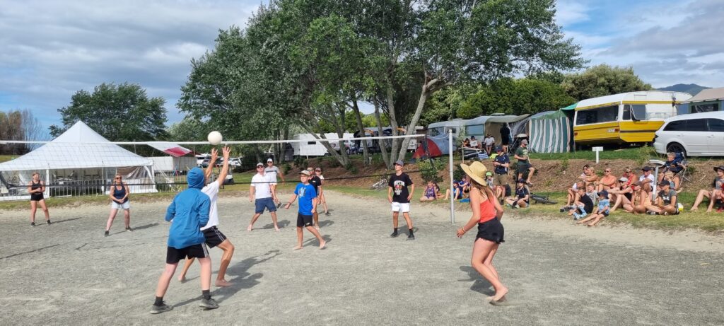 A group playing volleyball at Tāhuna Beach Holiday Park