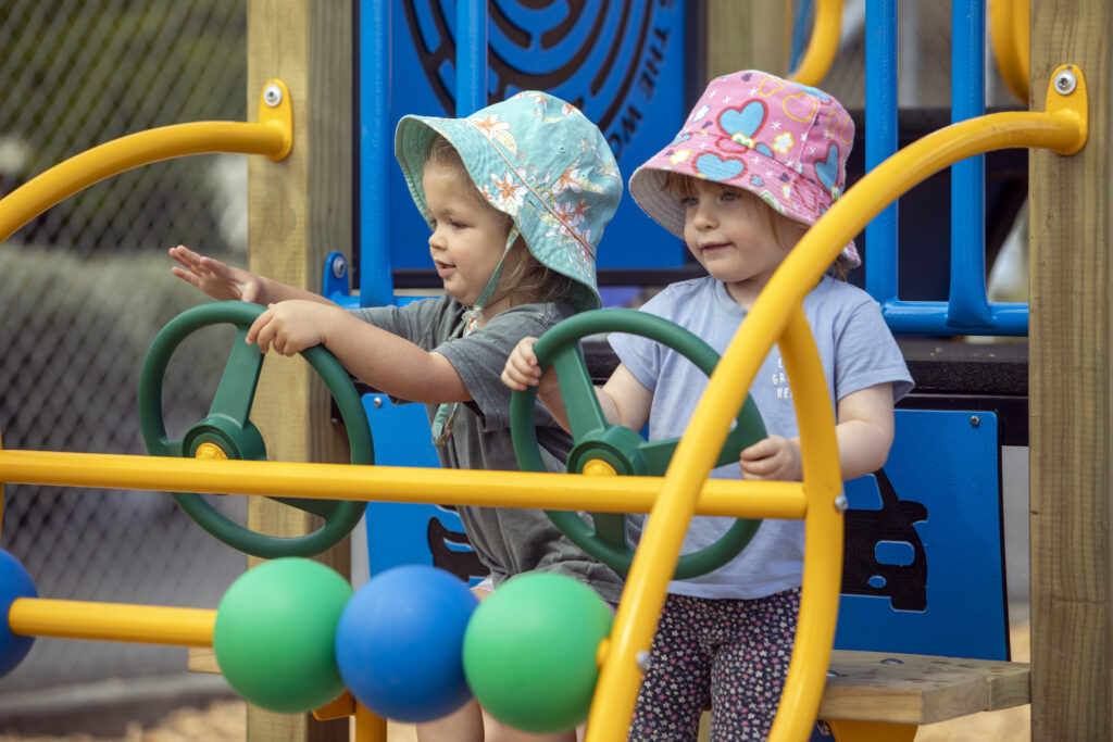 Kids playing in a playground at Tāhuna Beach Holiday Park